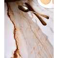 Sculpture Grande Porcelain Calacatta Maximus white marble-effect tiles with a gold cutlery set