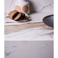 White marble countertop with subtle gray and beige veining in Sculpture Grande porcelain Calacatta Maximus design