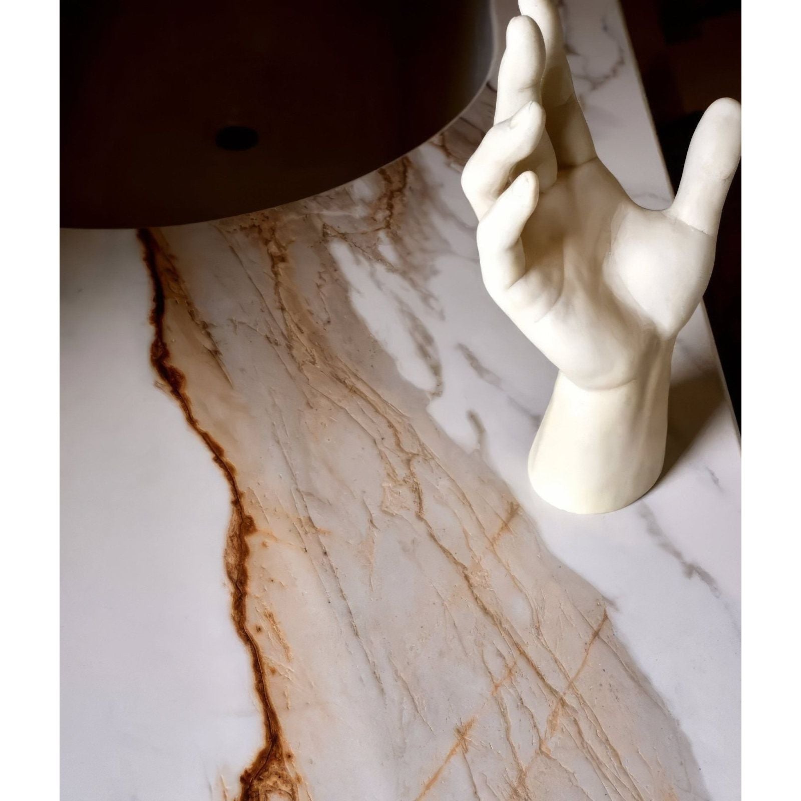 Cream-colored sculpture grande porcelain calacatta maximus countertop with elegant brown veining and marble finish