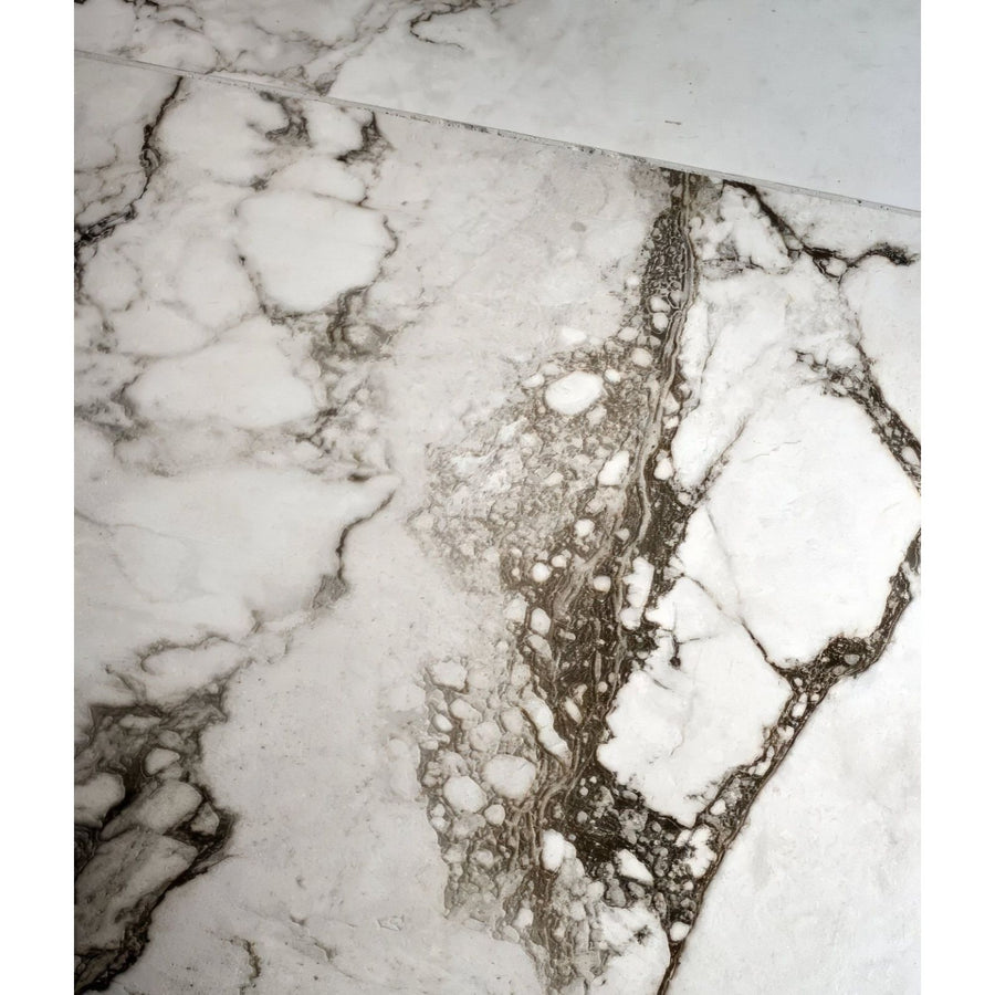 White marble porcelain tile sculpture grande cararra with intricate gray veining and glossy finish
