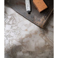 Sculpture Grande Porcelain Ceppo grey terrazzo-effect tiles with hand cream and soap