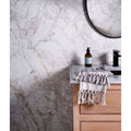 Sculpture Grande Porcelain Invisible Blue white marble-effect tiles with a woven towel on a vanity