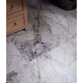 Sculpture Grande porcelain floor tiles with white and gray marble-effect and natural veining in invisible blue tone