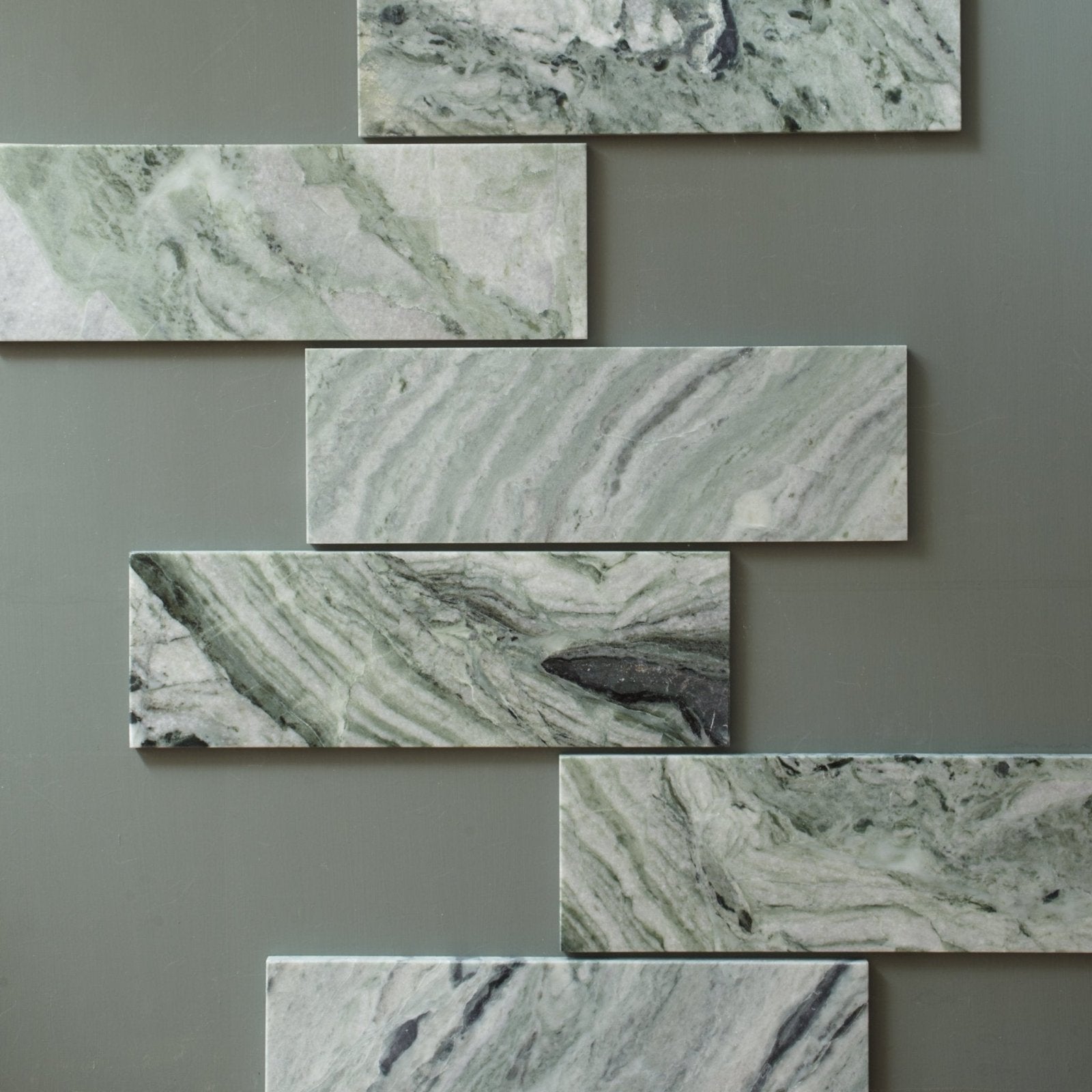 Seaspray green marble tile 10 x 30cm featuring green and white subway tiles with swirling veining patterns