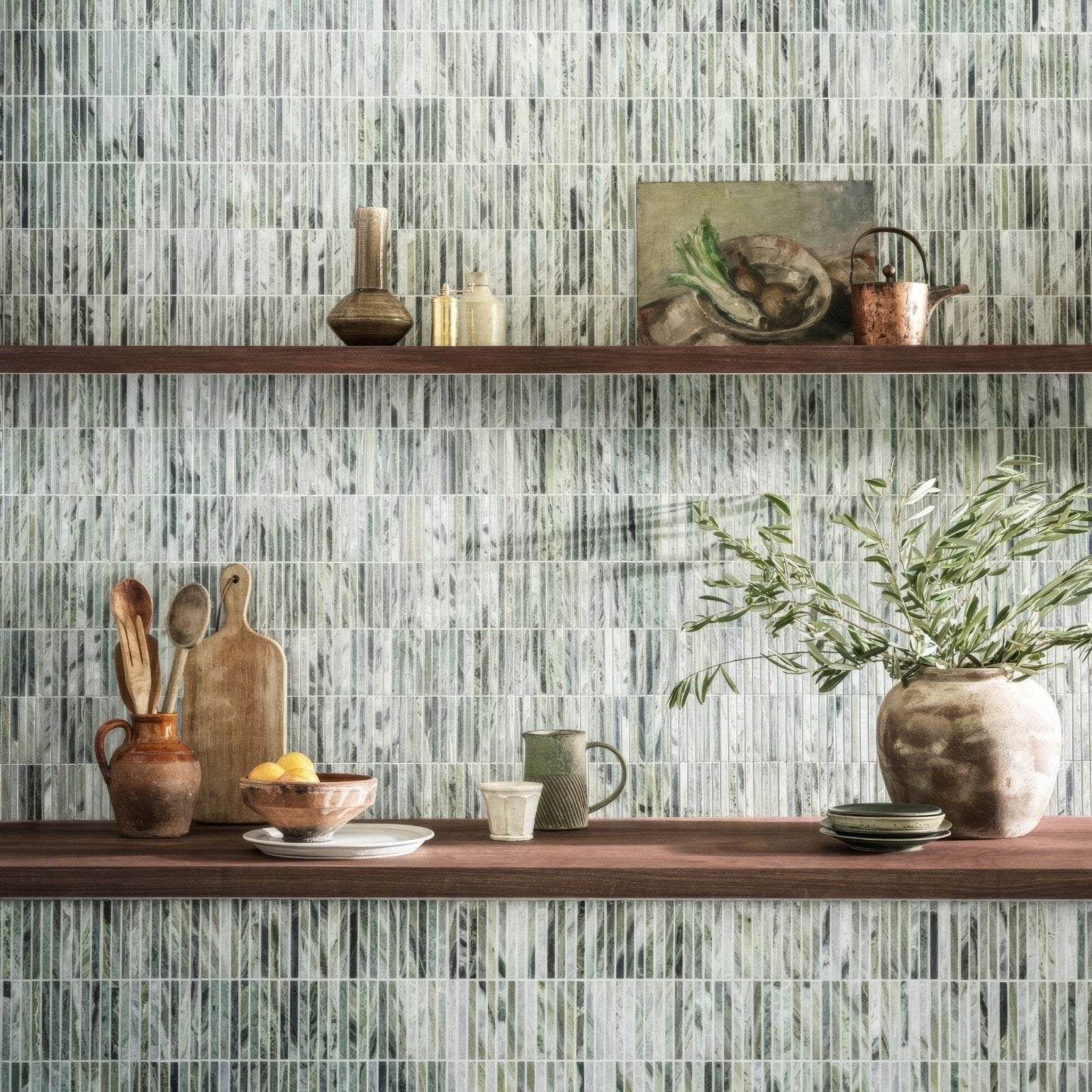 A seaspray green stacked mosaic ceramic vase with rustic textured surface and wide mouth holding olive branches