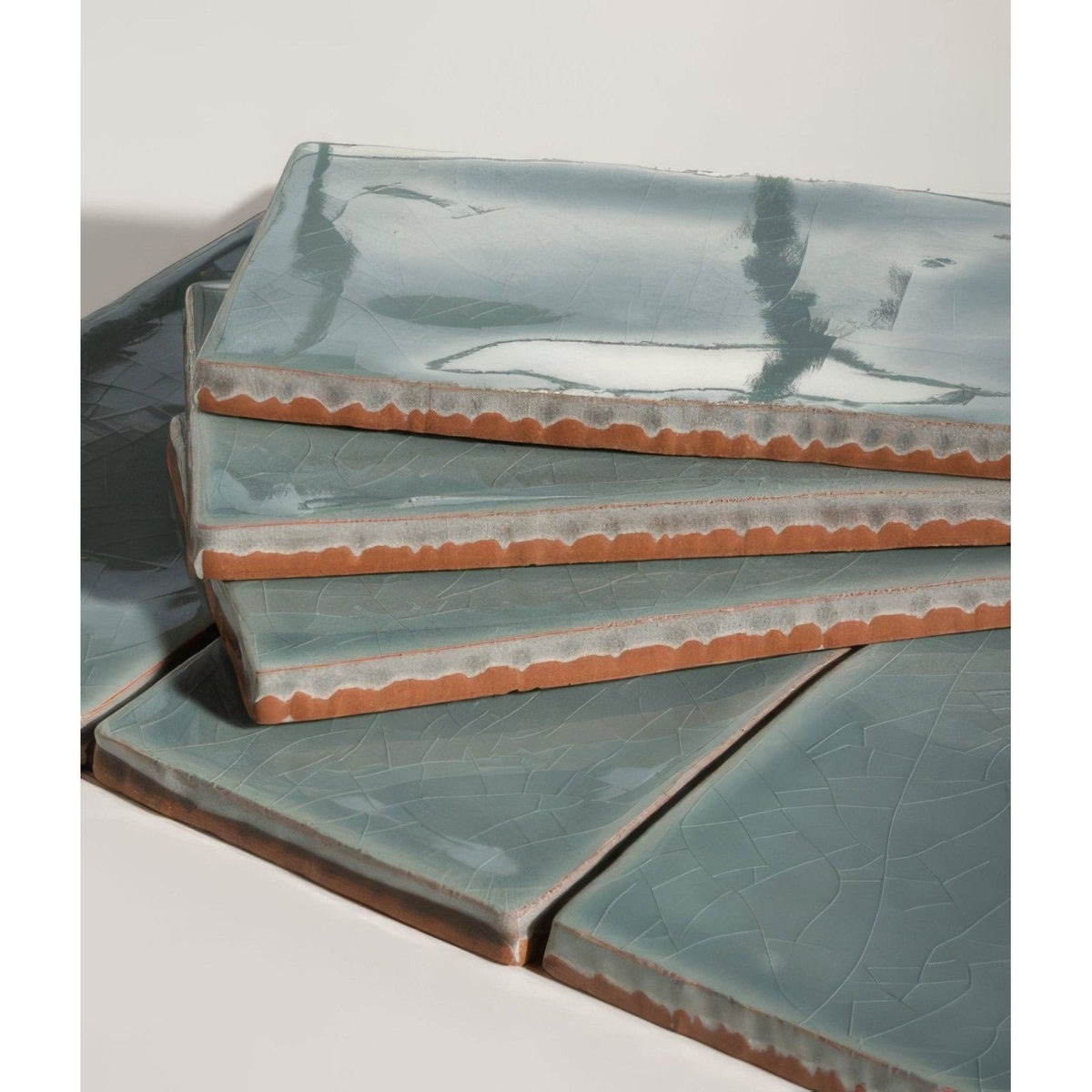 Stacked seaton ceramic rock pool tiles with matte teal glaze and rustic terracotta edges