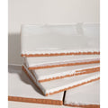 Stacked white ceramic salt tiles with rustic terracotta-colored edges for seaton ceramic salt product