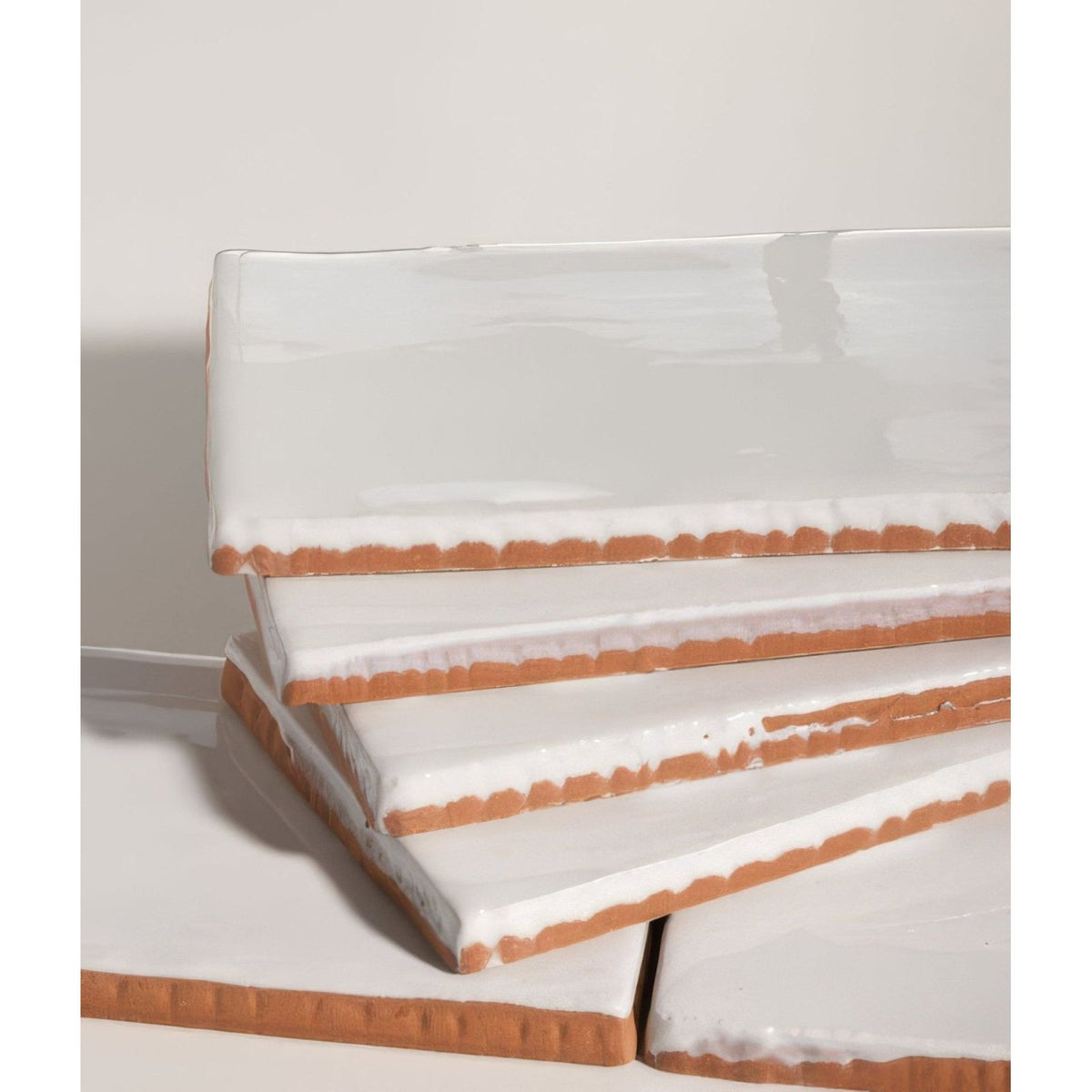 Stacked white ceramic salt tiles with rustic terracotta-colored edges for seaton ceramic salt product