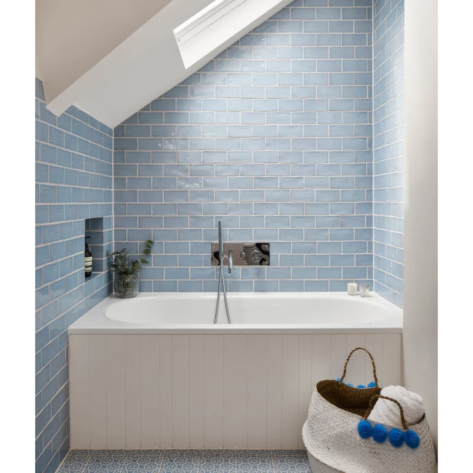 Light blue rectangular ceramic subway tiles with a glossy finish used on a bathroom wall from seaton ceramic sky