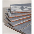 Stack of gray seaton ceramic sky tiles with crackled glaze and exposed terracotta edges