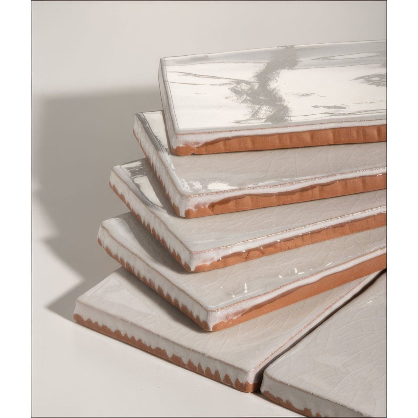 Stacked rectangular seaton ceramic white sands tiles with matte white glaze and exposed terracotta edges