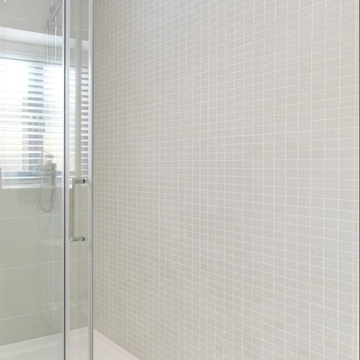 White square bianco mosaic tiles covering a bathroom wall showcasing the Select Bianco Mosaic product design