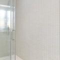 White square bianco mosaic tiles covering a bathroom wall showcasing the Select Bianco Mosaic product design