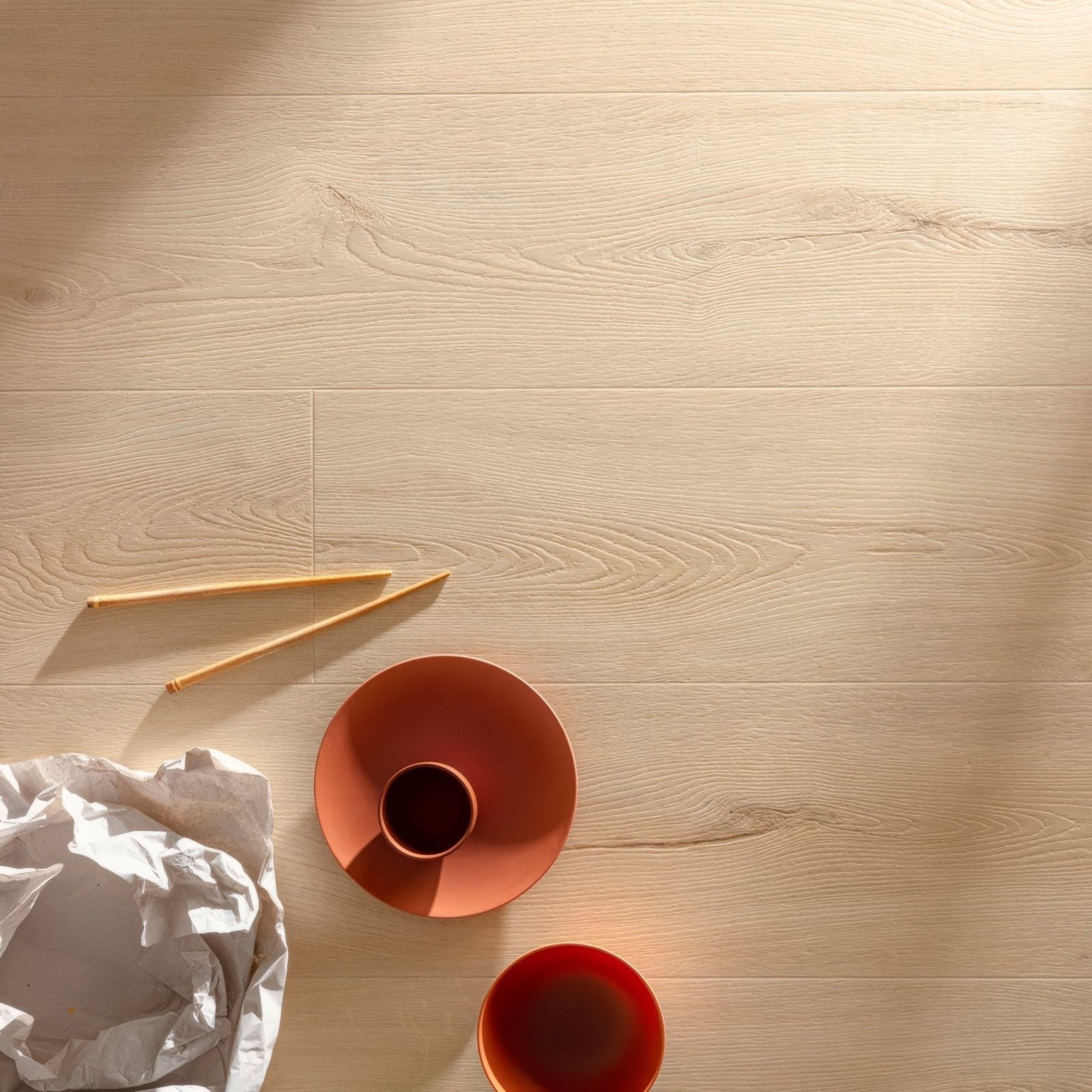 Terracotta ceramic bowl with matching cup on seychelles f100 xl vinyl planks light wood flooring