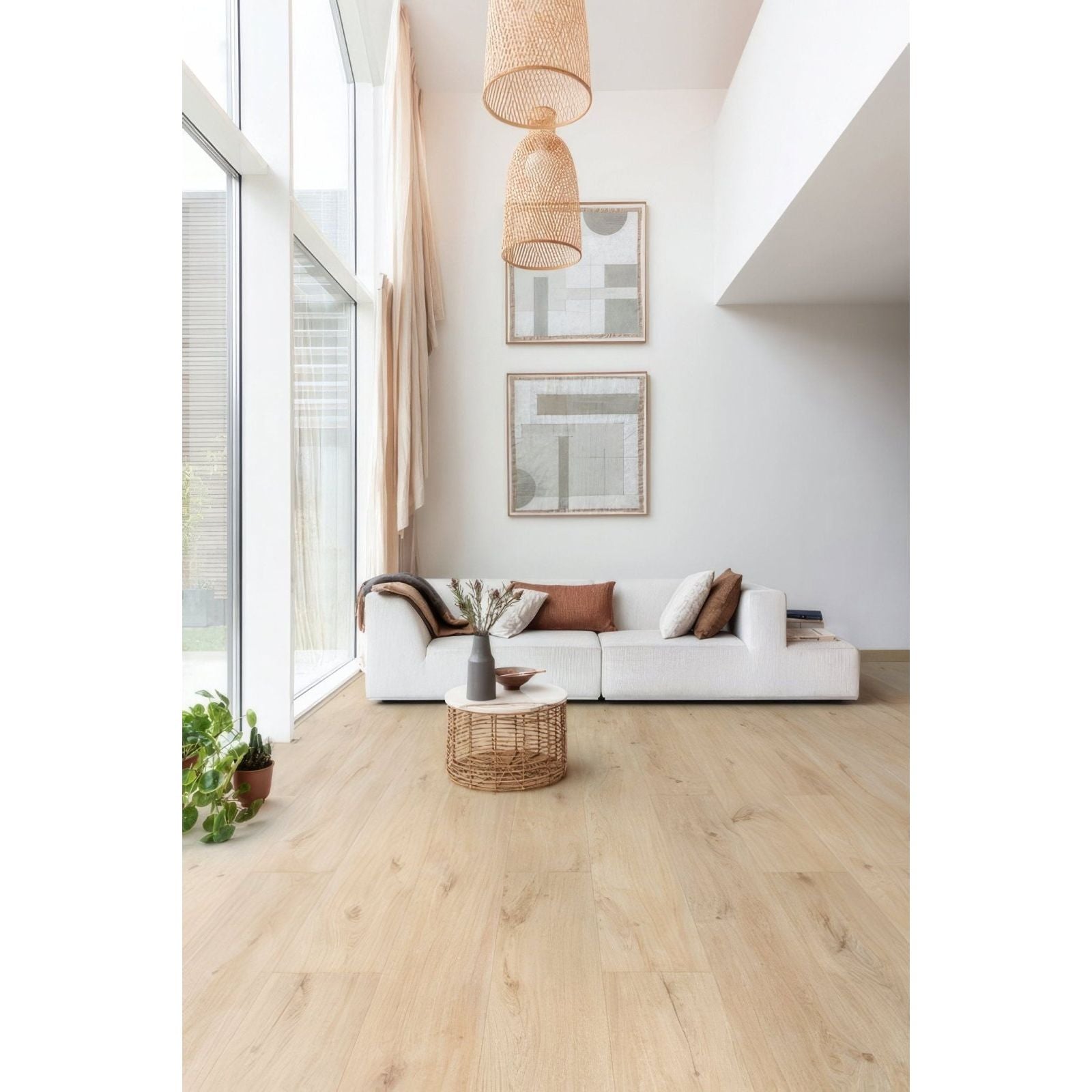 White sectional sofa with brown and beige throw pillows on Seychelles F100 XL vinyl planks flooring