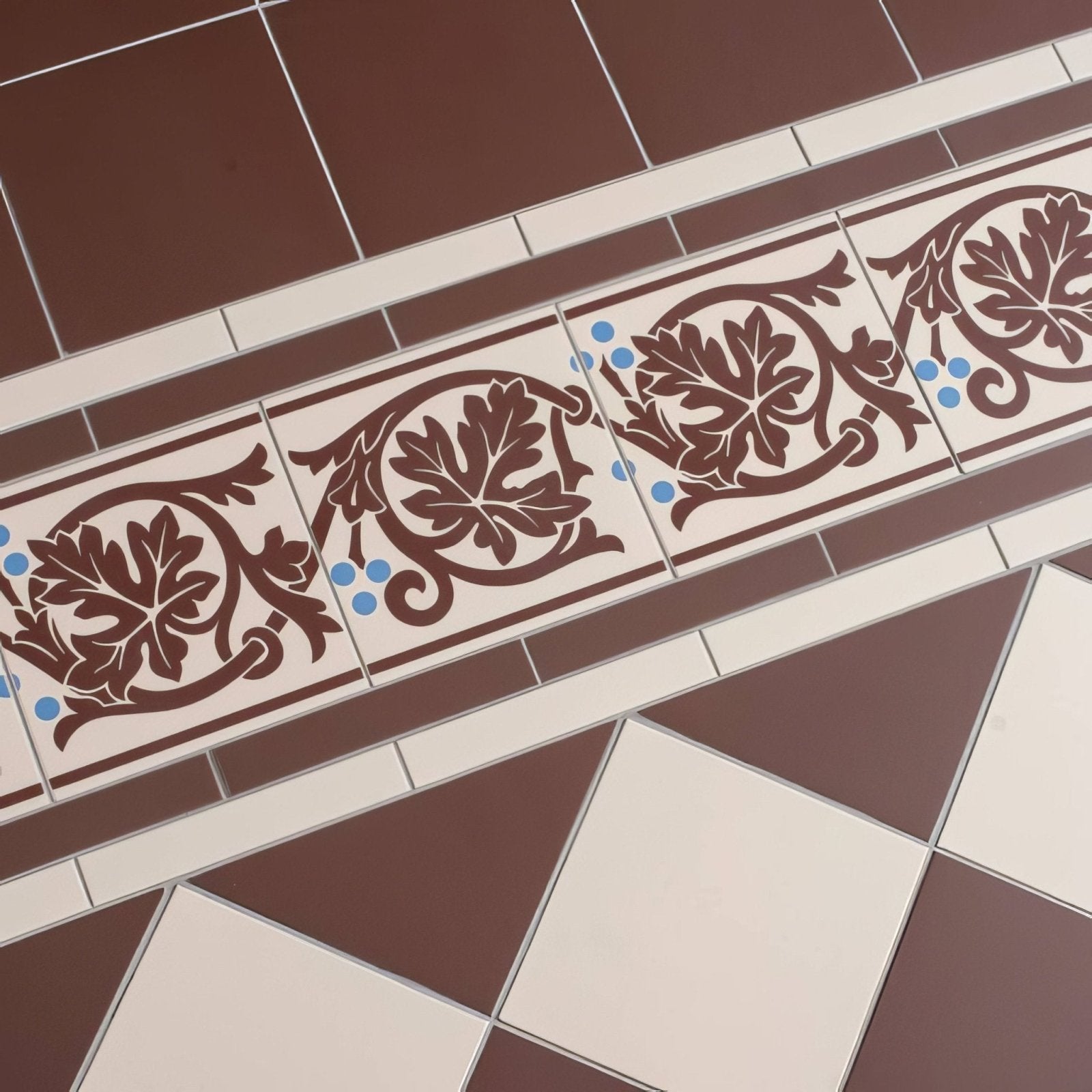 Shaftesbury 2 tile border brown on white decorative ceramic tiles with intricate leaf patterns and blue accents