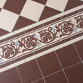 Brown and white ceramic tile border with intricate leaf patterns and blue accents shaftesbury 2 design