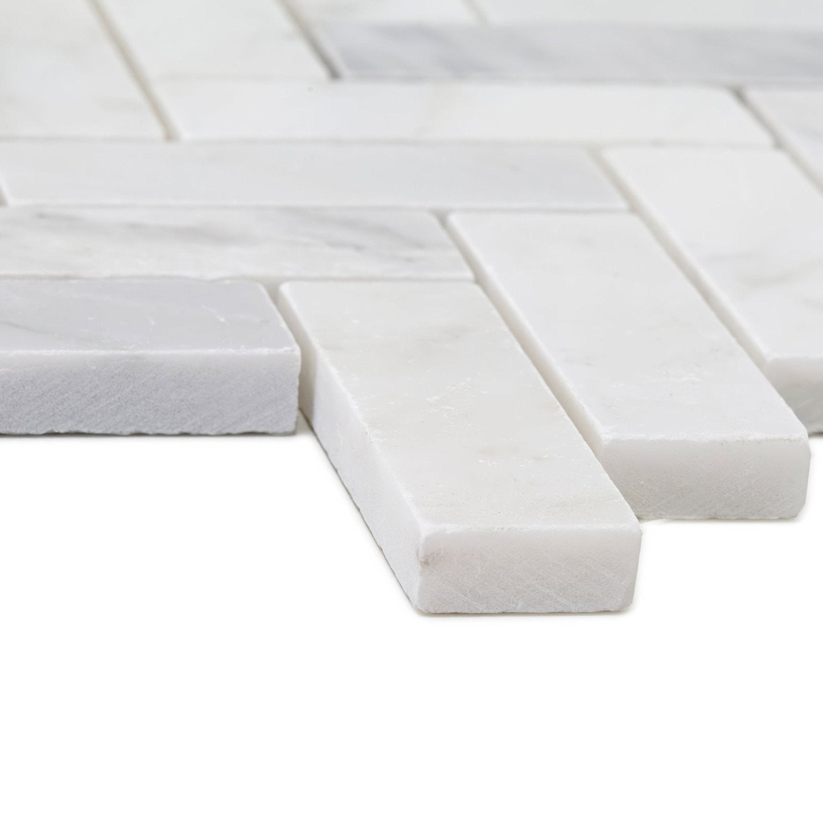 White marble mosaic tiles in herringbone pattern from east hampton shelter island marble mosaic collection