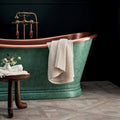 Sherwood Oak 80 x 80cm vintage-style copper bathtub with verdigris patina and ornate brass fixtures