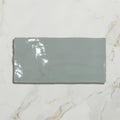 A sleek matte-finished gray ceramic rectangular tile with subtle glossy reflections from shorelin ceramic sea kale