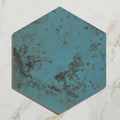 Hexagonal porcelain tile with distressed turquoise finish and dark patina accents from Signature Porcelain Verdigris collection