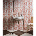 White ceramic silk screen sink with ornate chrome legs and classic faucet against bamboo-patterned lantau tiles