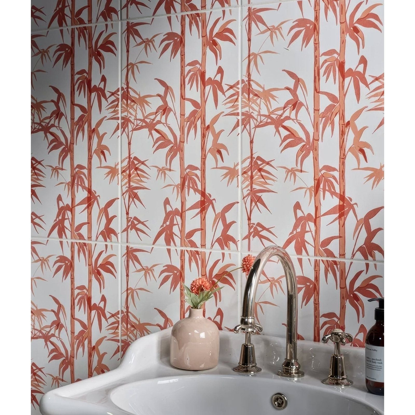 A sleek curved chrome faucet with ornate handles on a white sink for the silk screen ceramic lantau bamboo incardine