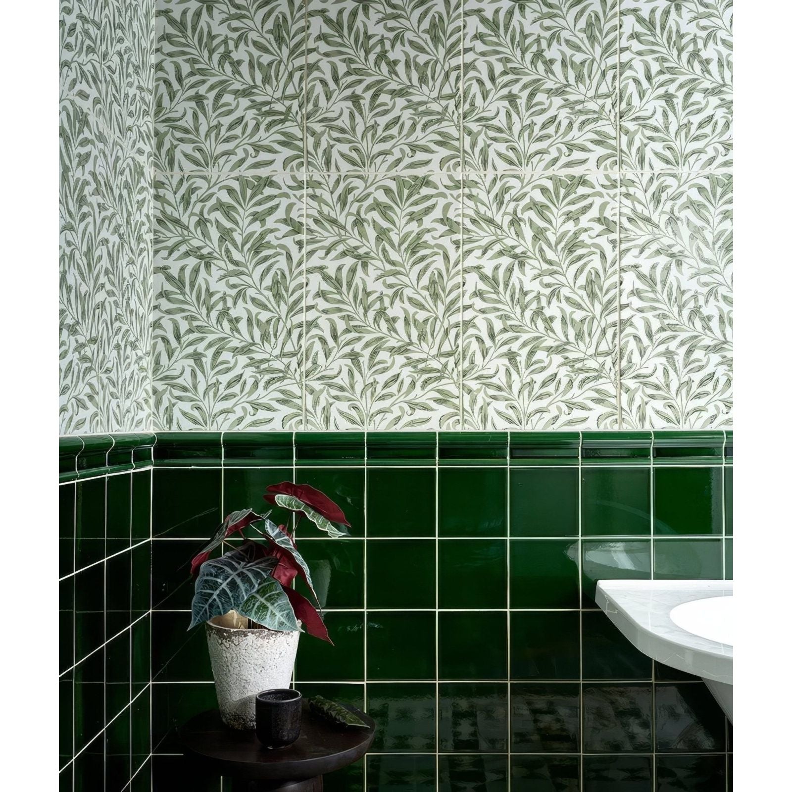 A silk screen ceramic willow cottage spring leaf potted plant with variegated green and deep red leaves in an off-white pot