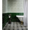 White clawfoot ceramic bathtub with gold feet featuring silk screen willow cottage spring leaf design