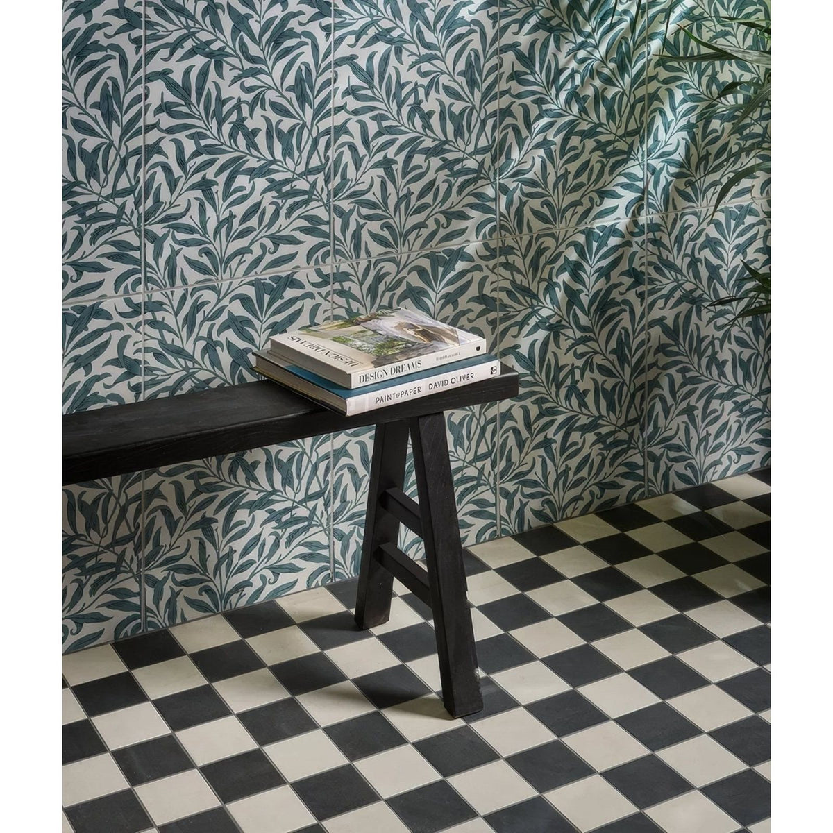 Black wooden bench with simple sturdy design and three legs featured in silk screen ceramic willow cottage teal product