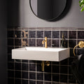 White rectangular wall-mounted sink with gold faucet and matching plumbing featured with sloe field tile background
