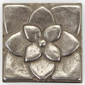 Small foundry lotus inset silver metallic square tile with raised embossed five-petal flower design and central dot