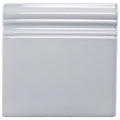 White ceramic snape skirting tile with glossy finish and decorative ridged border for wall accents