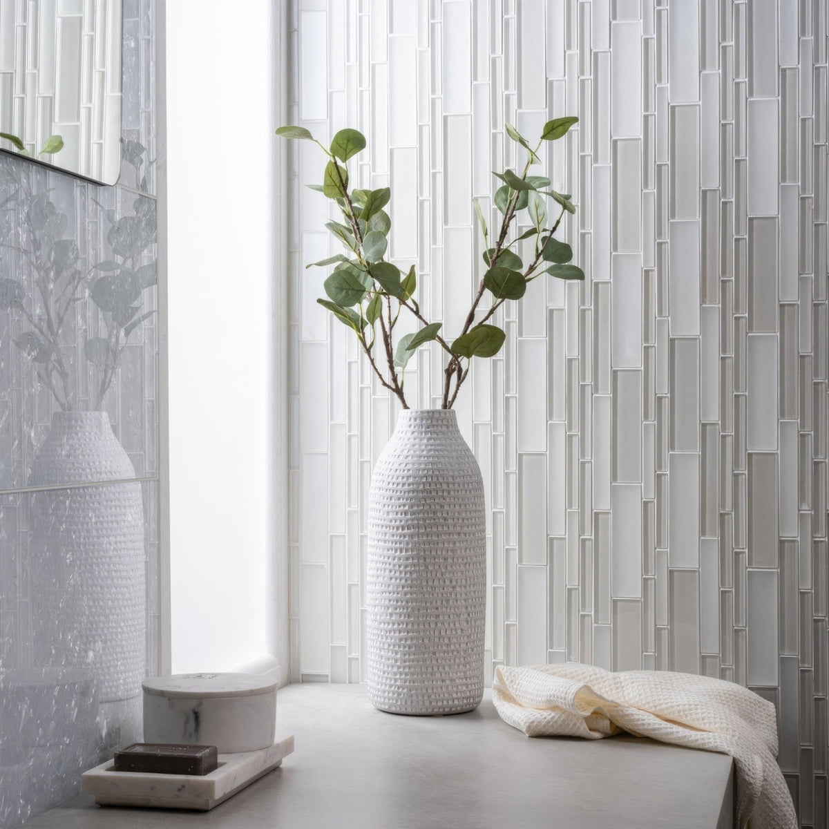 
Solinda Mixed Format Mosaic silver glass mosaic with a woven ceramic vase of eucalyptus