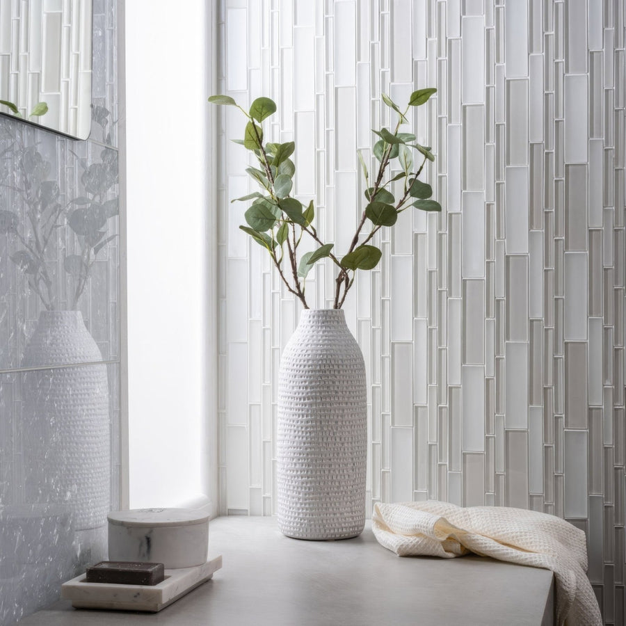 Solinda Mixed Format Mosaic silver glass mosaic with a woven ceramic vase of eucalyptus