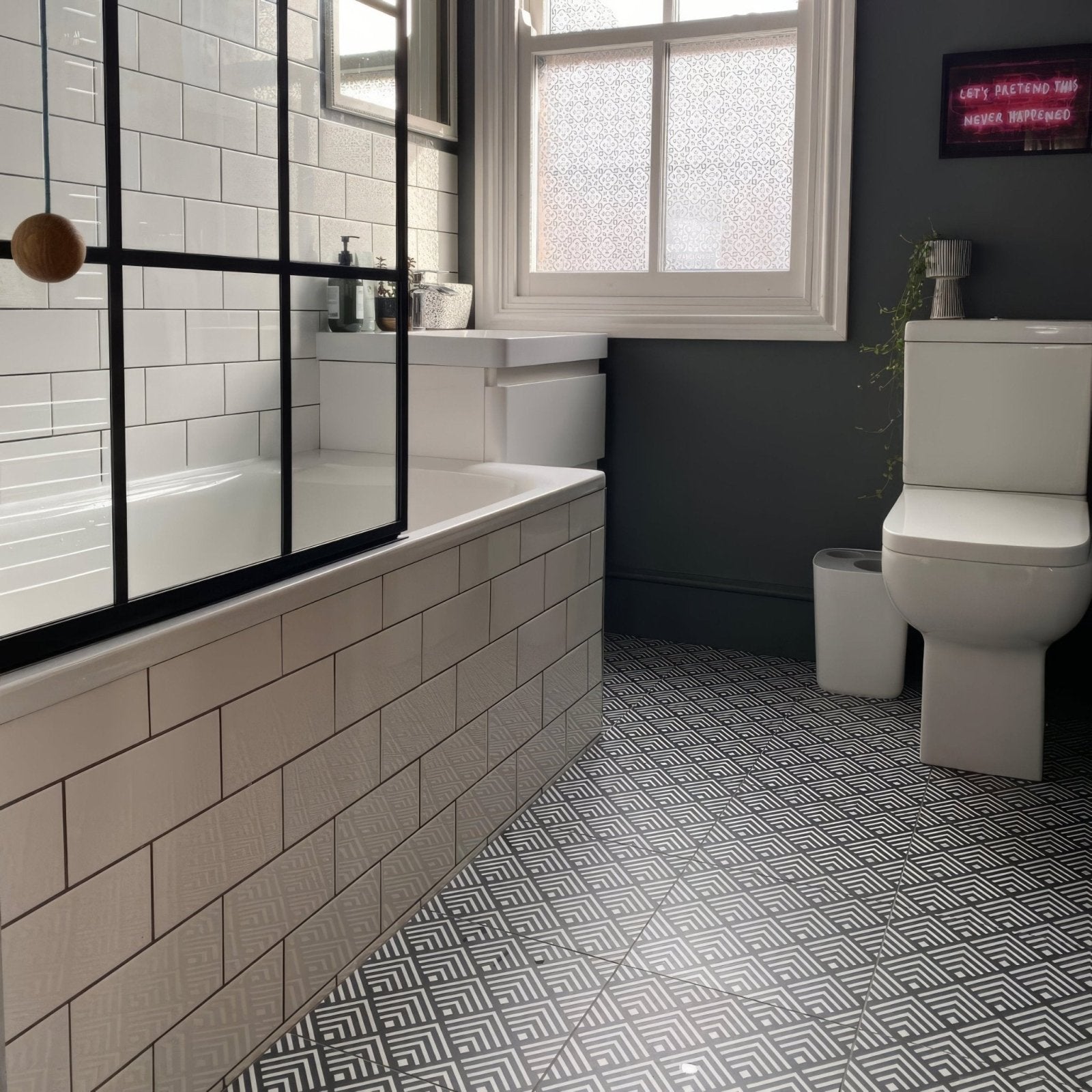 White subway tile bathroom wall with black metal frame shower enclosure featuring sorrento correale porcelain tile