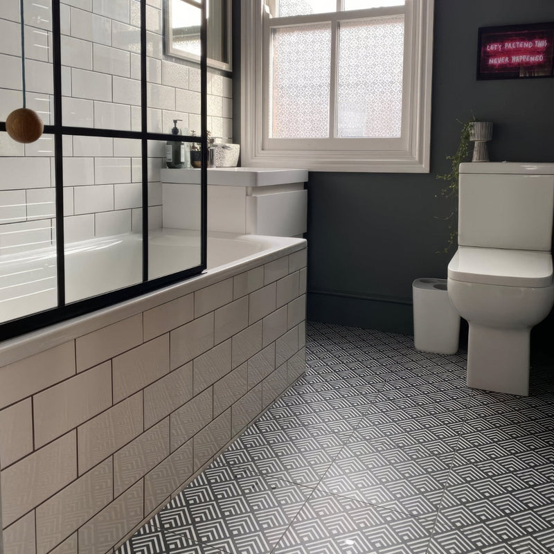 Sorrento Correale Porcelain Tile on a bathroom floor with white brick tiles on the walls