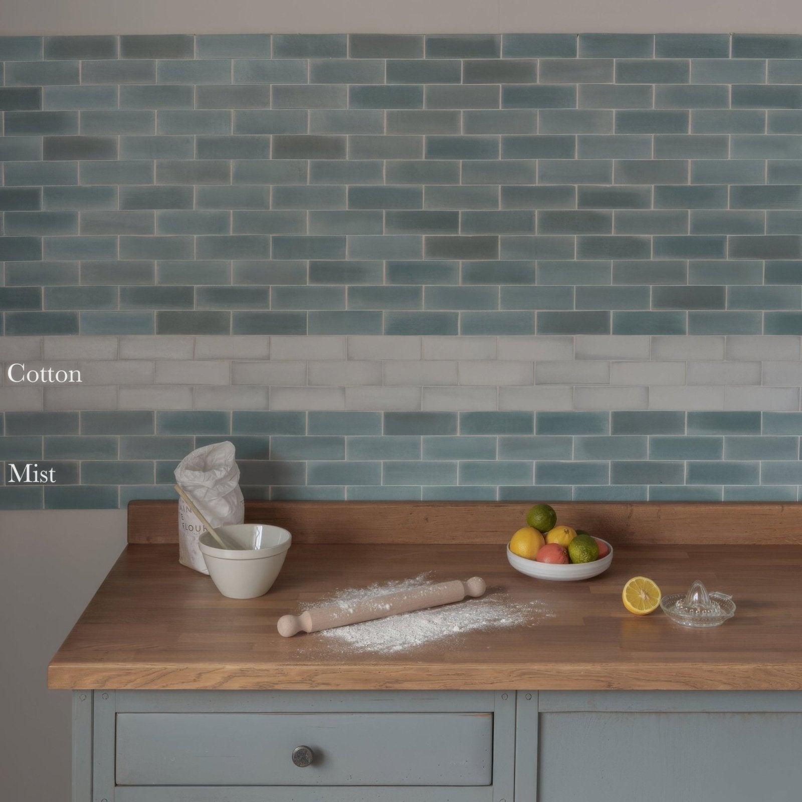 South Cliff cotton brick tile backsplash with glossy teal blue rectangular tiles arranged in a classic brick pattern