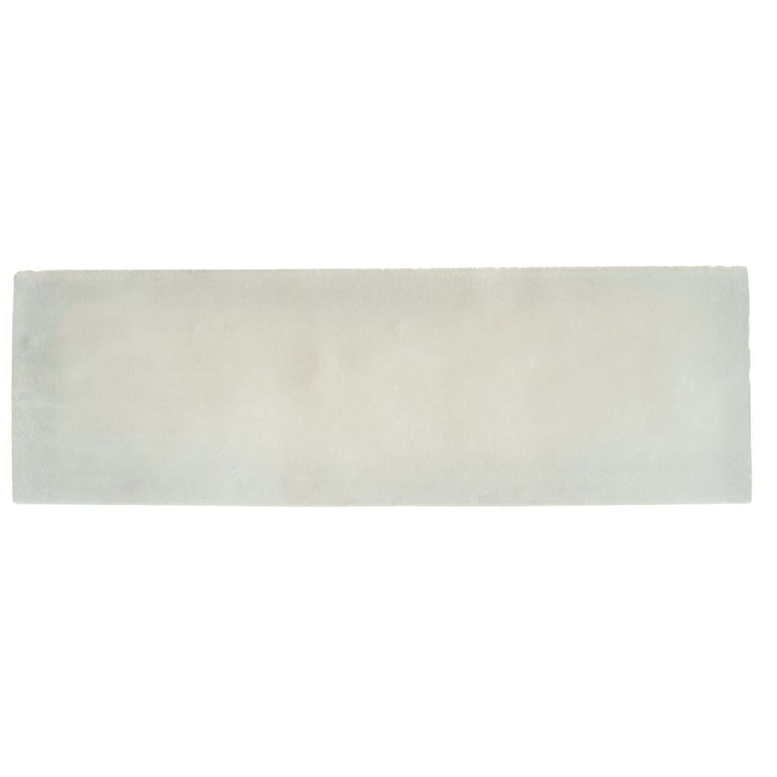 South Cliff Cotton Brick Tile is an off-white rectangular ceramic tile with smooth texture and subtle gray veining