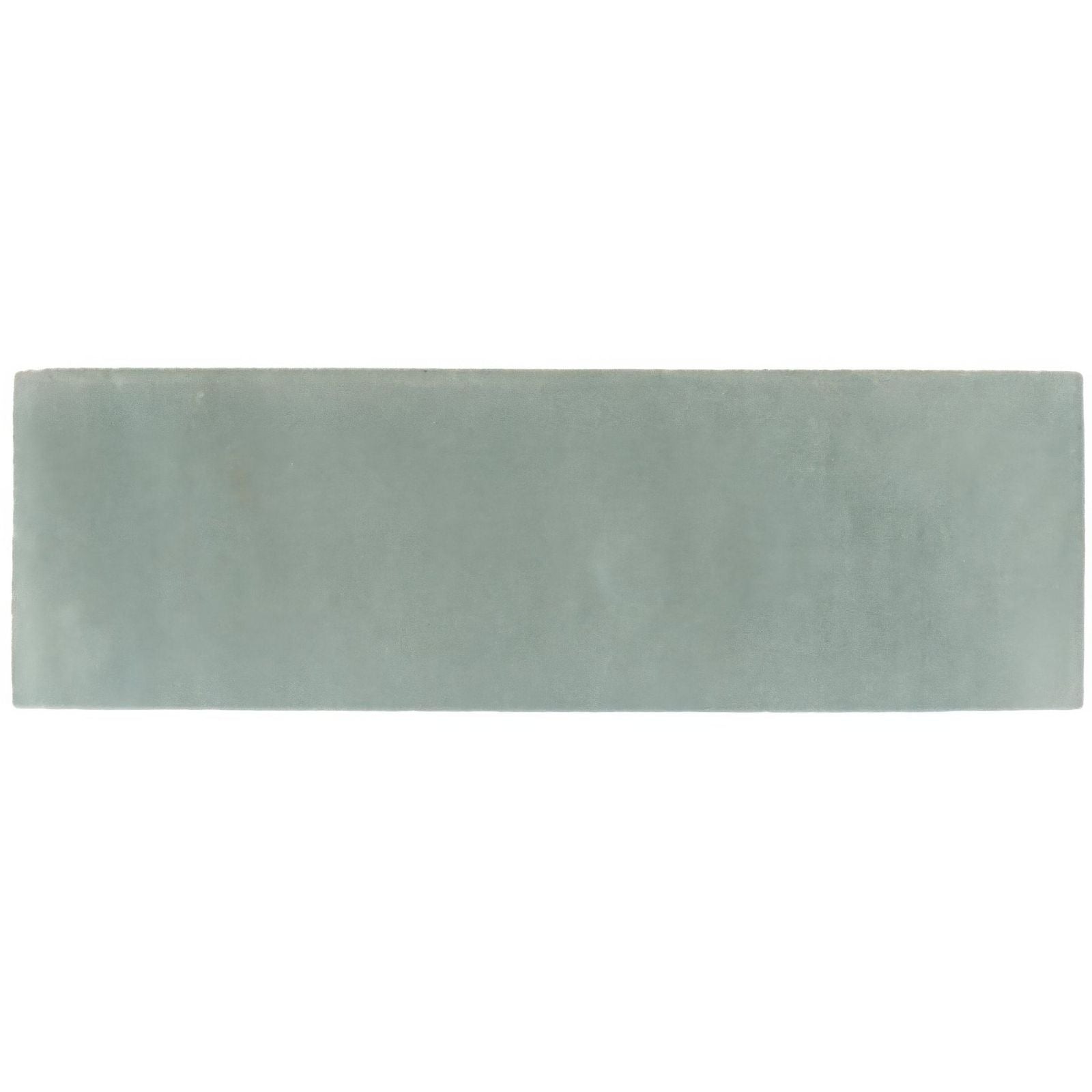 A rectangular matte ceramic tile in soft sage green from the south cliff mist brick tile collection