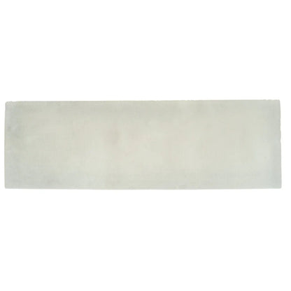 A rectangular off-white ceramic south cliff cotton brick tile with a smooth slightly textured surface and subtle tone variations