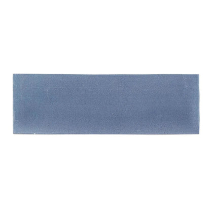 A rectangular matte-finished blue ceramic tile with a subtle textured surface from south cliff ocean brick tile