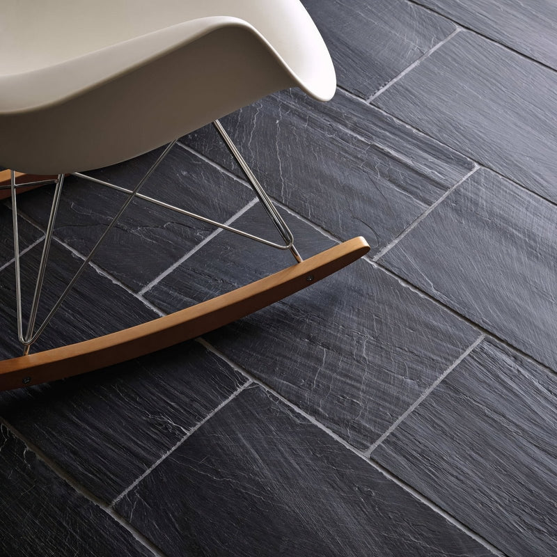 Dark gray slate-effect spanish black 25 x 40 chipped edge riven floor tiles with natural texture and subtle white grout lines