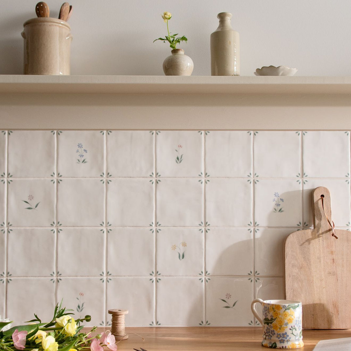 Off-white ceramic Spring Alice tiles 13 x 13cm with delicate gray floral and starburst patterns arranged in a grid