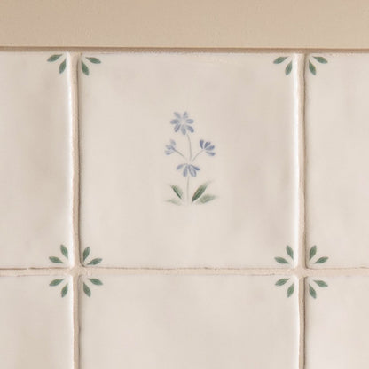 Off-white ceramic spring alice tiles 13 x 13cm with delicate hand-painted blue and green floral motifs