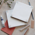 White ceramic spring april blush tile 13 x 13cm with delicate pink and green floral accents at each corner
