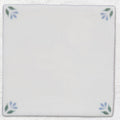 White ceramic tile spring april cornflower 13 x 13cm with delicate blue and green leaf motifs at each corner