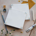 White ceramic spring april primrose 13 x 13cm tiles with delicate floral motifs in soft green and beige tones