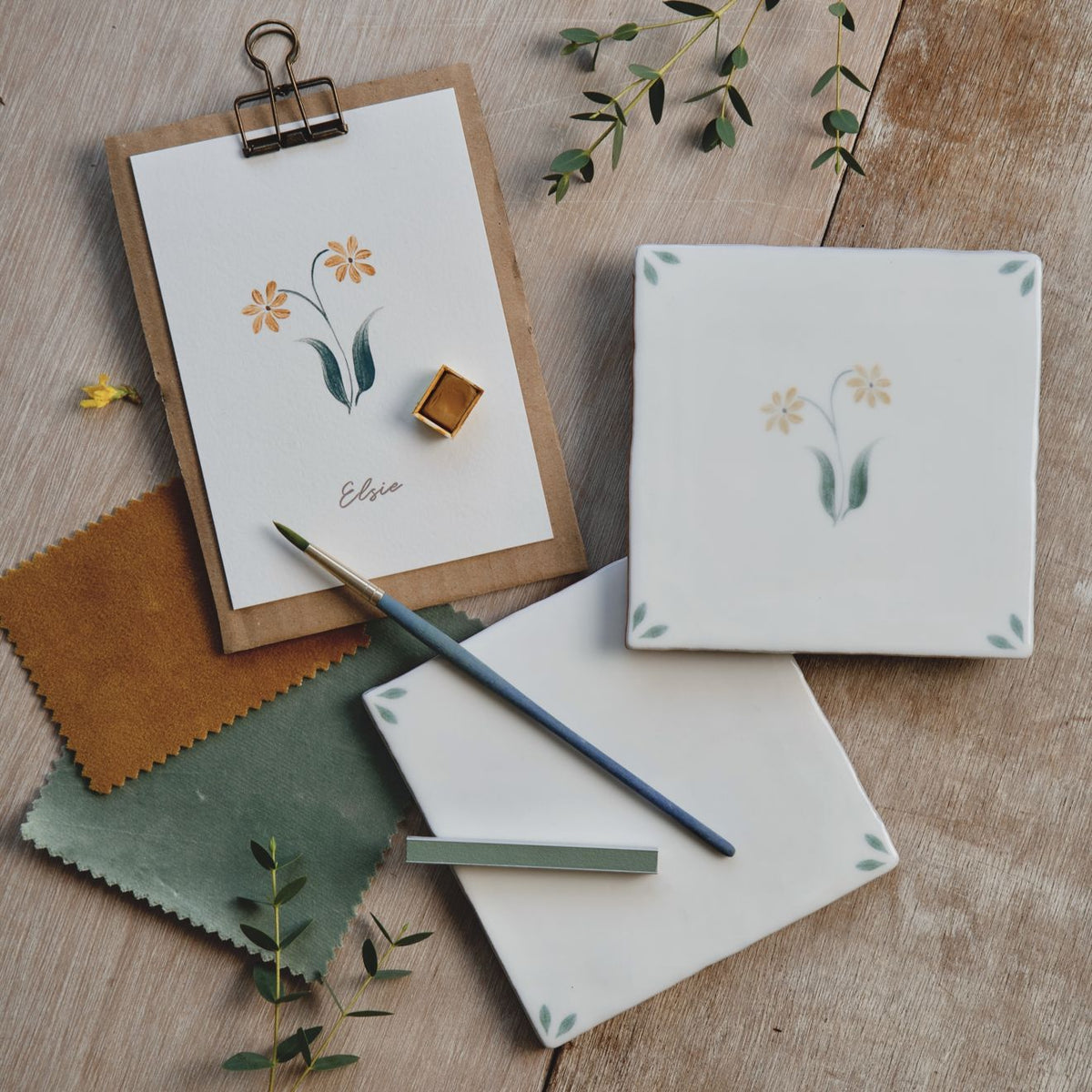 White ceramic tile with delicate hand-painted yellow and green floral design spring elsie 13 x 13cm