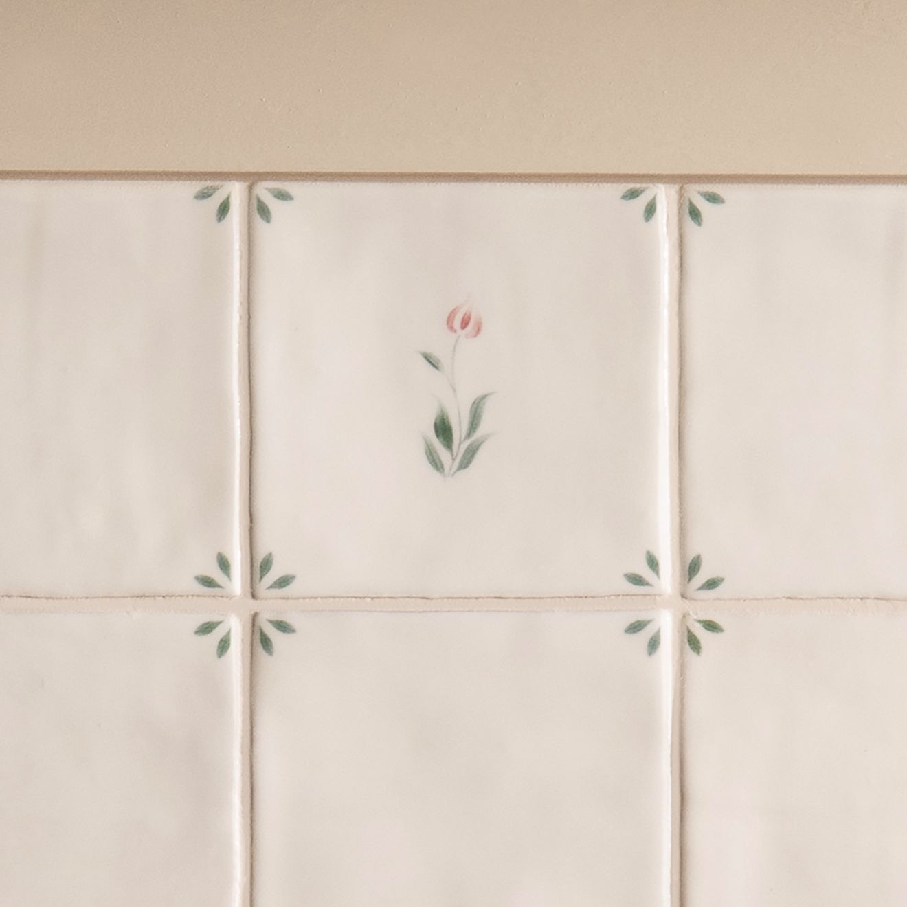 Off-white ceramic spring emma tile 13 x 13cm with delicate hand-painted pink and green floral motifs